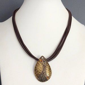 Hammered brass pendant w/crystal accent on cording